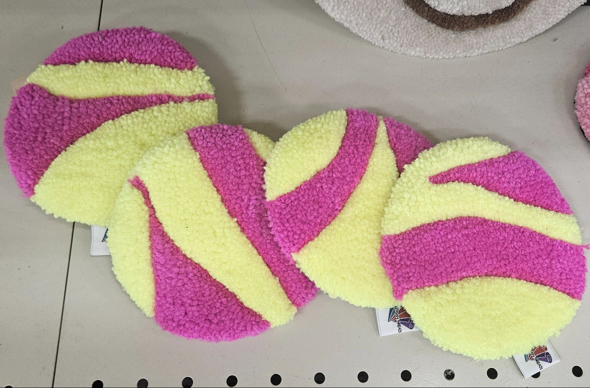Hand-tufted fiber art coaster set in bright pink and pale yellow
