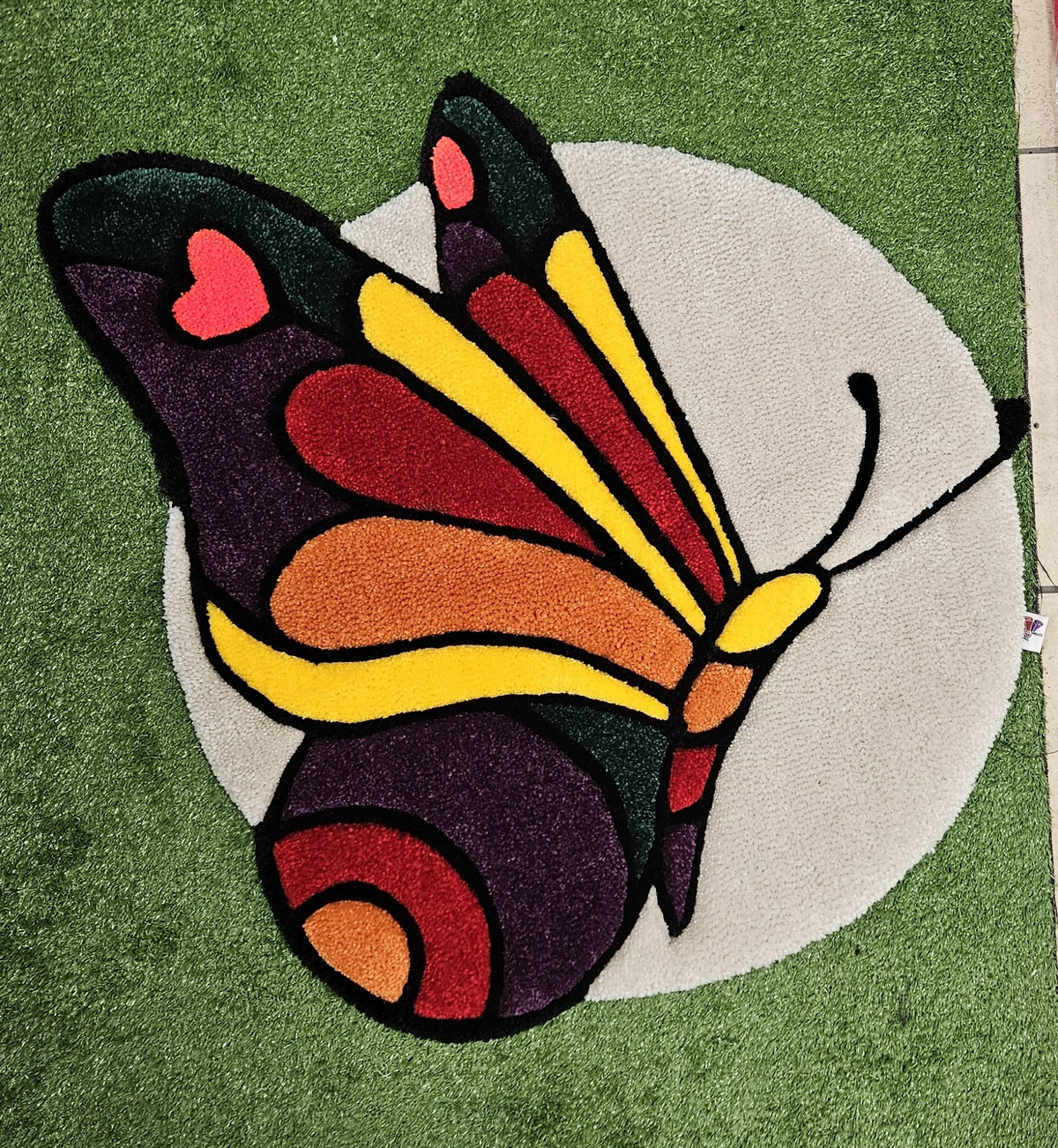 Butterfly Bloom multicolor hand-tufted functional fiber art on cream background