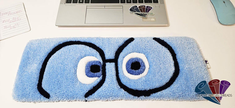 Sadness Eyes hand-tufted fiber desk art with expressive blue eyes