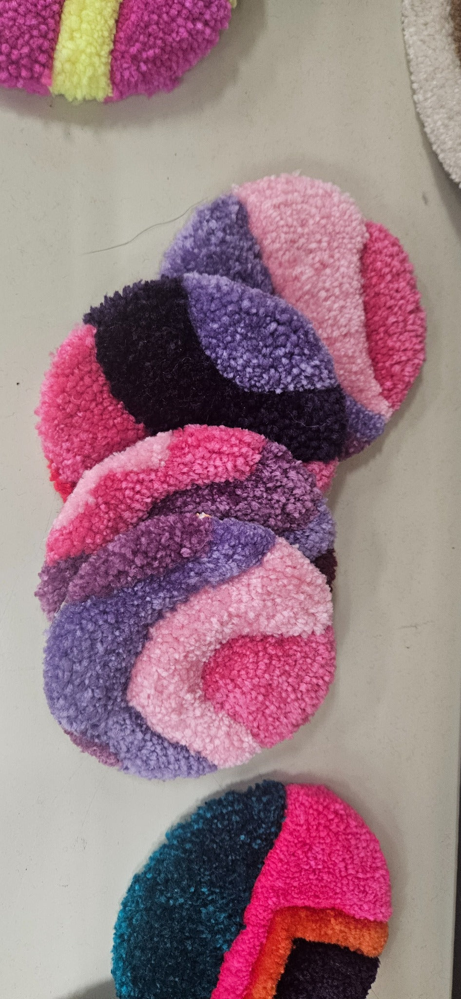 Hand-tufted fiber art coaster set in purple, lavender, pink, and plum