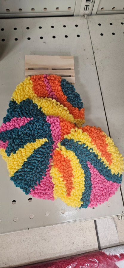 Hand-tufted fiber art coaster set in orange, yellow, teal, and pink